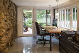 An office with granite floors, stone walls, and a generous array of windows is adjacent to the front entry of the house, and is a great spot for observing wandering wildlife.
