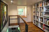 At the top of the stairs leading up from the living room is a mezzanine library with window seat overlooking woods and creek. The original wide-plank heart pine floors are the same that can be found in the master bedroom.