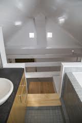 Across the ceiling joists from the MBR bath is the original chimney no longer in service. These curved sections often hidden in attics were assumed to improve the draw of the wood stove smoke.