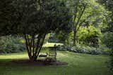 Perennial and vegetable gardens are woven around various outbuildings, including art studio and wood shop.