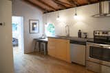 The birch flooring and pine rafters help create a nest-like feeling in the wooded surroundings.