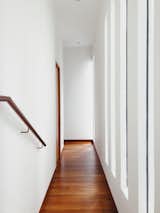 Hallway and Medium Hardwood Floor Light filled corridor towards back of house.   Photo 12 of 18 in 16A Residence by Studio Roundtop
