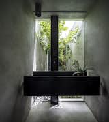 Round Edge House by Anderman Architects black iron sink