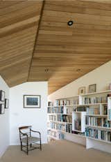 The library features bespoke shelving built by Featherstone Young and natural sisal carpeting.