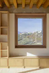 Wooden windowframes have been introduced, with each window carefully positioned to frame the surrounding mountainscape.