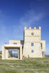 The home wraps around the watchtower.