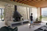 The steel fireplace, designed by Map Architetti, sits against a wall of the watchtower, which is incorporated into the living room.