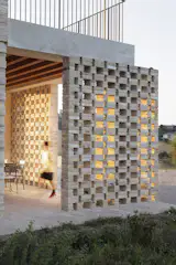 The latticed pergolas allow for family activities to take place outside while sheltering inhabitants from intense sun and wind.