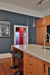 The play with  bright and bold colors was a large part of the design for the owner as the small hallway leading to the office and bedrooms is painted red.