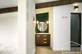 In the master suite, a touch of the basement's deep green is represented again, carried from behind the vanity, into the shower wetroom which houses the toilet and showering area.