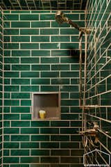 The master wet room boasts brass fixtures and recessed niches for practicality.