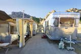 A very rare 1954 Spartan Manor vintage trailer, large patio, furnished gazebo, and 2nd 1963 trailer are tucked under the sandstone cliffs.