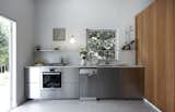Stainless steel Ikea kitchen elevated by the cherry wood cabinetry