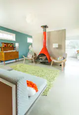 Designed specifically for, and around, this vintage fireplace, this 2014 addition provides an extra living room to the 1958 home.