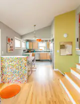 A lego wall sets the stage for this colorful, open floor plan.