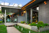 Floor to ceiling windows brought this home to its original state. Concrete planters and a flat roofed porch added a more modern feel to this 1958 home.