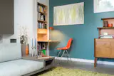This space-saving pull out bookshelf/desk houses the water heater closet for the heated floor.