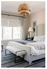 The master bedroom assumes a "layered, masculine vibe" that plays off the sweeping tree views outside. A wood-inspired light further plays off the views.