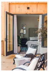 The stunted marble table highlights the views, while the laidback white armchairs let the views take center stage.