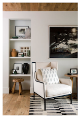 A subdued loft area makes use of Cartwright's vast collection of vintage furniture and textiles, while the shelves display all her beloved artwork.