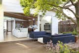 Outdoor, Wood Fences, Wall, Wood Patio, Porch, Deck, Back Yard, Flowers, Trees, Garden, and Small Patio, Porch, Deck Large sliders blur the line between indoors and out and expand the living space.  Photo 5 of 10 in Hedge by Quarry Hill Consulting