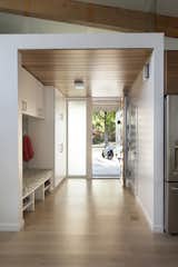 Hallway and Light Hardwood Floor Built in storage keeps the entryway clear of clutter.  Photo 6 of 10 in Hedge by Quarry Hill Consulting