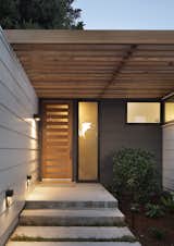 Entry way has a modern feel with custom door and lighting.
