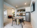 Kitchen, Drop In Sink, Refrigerator, Engineered Quartz Counter, Vinyl Floor, Ceiling Lighting, White Cabinet, and Mirror Backsplashe Well-lit pantry perfect for a cuppa.  Photo 10 of 14 in The Leading Edge : SQR Architecture & Interior Design by SQR Architecture + Interior Design