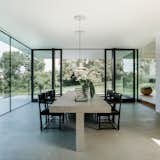Dining Room, Chair, Table, Limestone Floor, Gas Burning Fireplace, Lamps, and Ceiling Lighting dining room  Photo 3 of 13 in Villa Philipp by PHILIPPARCHITEKTEN // anna philipp