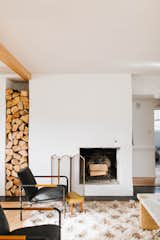 Living Room, Recessed Lighting, Light Hardwood Floor, Chair, Wood Burning Fireplace, and Coffee Tables Living room After shot December 2018 - stucco fireplace with original wood burning insert.   Photo 13 of 16 in 1940's mid-century home gets a swift kick in the pants. by The Chris & Claude Co