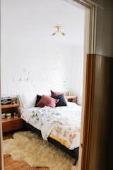 Master bedroom. We kept the original wallpaper on the bottom half of the wall & exposed plaster & brick on the top section of the wall. 