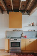 Pear colored kitchen in all her modern-wanna-be-retro glory! We exposed the ceilings & the original floors - but gutted everything in between. 