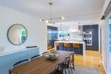 Kitchen, Ceiling Lighting, Refrigerator, Wall Oven, Range Hood, Range, Microwave, Medium Hardwood Floor, Subway Tile Backsplashe, Pendant Lighting, and Undermount Sink  Photo 2 of 27 in Lookout House by Robert Hintz