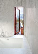 Lined with marble, the master bathroom provides a cool retreat to take in the view.