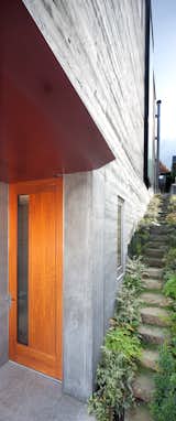 Front entry. Basalt steps and native vegetation lead up to the rear yard.