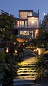 From the street, basalt steps and a lush landscape lead up to
a facade of board-formed concrete and Ipe siding.