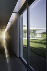 The project is laid out as a series of garden rooms. Privacy is modulated by solid white walls, which extend from deep within the house, into the landscape outside. Material and color choices are restrained, so that the building can be a blank canvas for the play of natural and artificial light. 