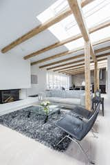 The staircase leads up to the living room, which is planned around the fireplace at the opposite end of the kitchen on the first floor. Both the stairs and the floors feature wide Dinesen Douglas Pine floorboards. Eilersen sofa. The round armchair is an Eera Aarnio ‘Ball Chair’. 