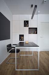 Office, Shelves, Medium Hardwood Floor, Bookcase, Lamps, Chair, Desk, and Study Room Type  Photo 11 of 25 in Stripe by Olga Kravchuta