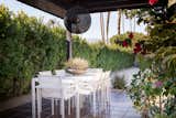 Outdoor, Walkways, Hardscapes, Trees, Gardens, Shrubs, Hanging Lighting, Flowers, Back Yard, Garden, and Tile Patio, Porch, Deck Outdoor dining area  Photo 20 of 52 in 70's Architectural Home in Rancho Mirage by Dane Kealoha