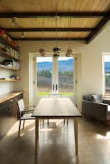 Enhanced by views of the landscape, the flexible dining room table doubles as a workspace.