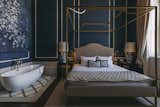 The blue-and-white "Porcelain" room features a canopy bed and a mix of velvet, brass, and wood.