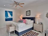 Bedroom, Lamps, Light Hardwood, Table, Recessed, Bed, Rug, Night Stands, and Bench One of the bedrooms sporting a navy-centric palette.  Bedroom Night Stands Bench Table Rug Light Hardwood Lamps Photos