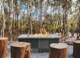 Log seating around the fire pit reinforces Kūono's relationship with nature.