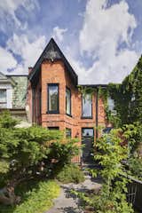 The modern extension in back belies the historic brick facade.