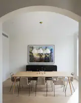 The understated dining room, where eating takes place underneath a modern, elegant white chandelier.