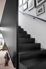 Black metal and wood define this staircase leading to the guest suite over the garage.