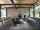 Serenity House by Dupont Blouin dining and living room with river rock wall