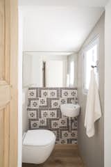 Tiles from an 18th-century Naples factory add pattern to a compact bathroom. 