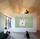A projector that casts images upon a white, floating pavilion is embedded in the media/playroom's millwork.

